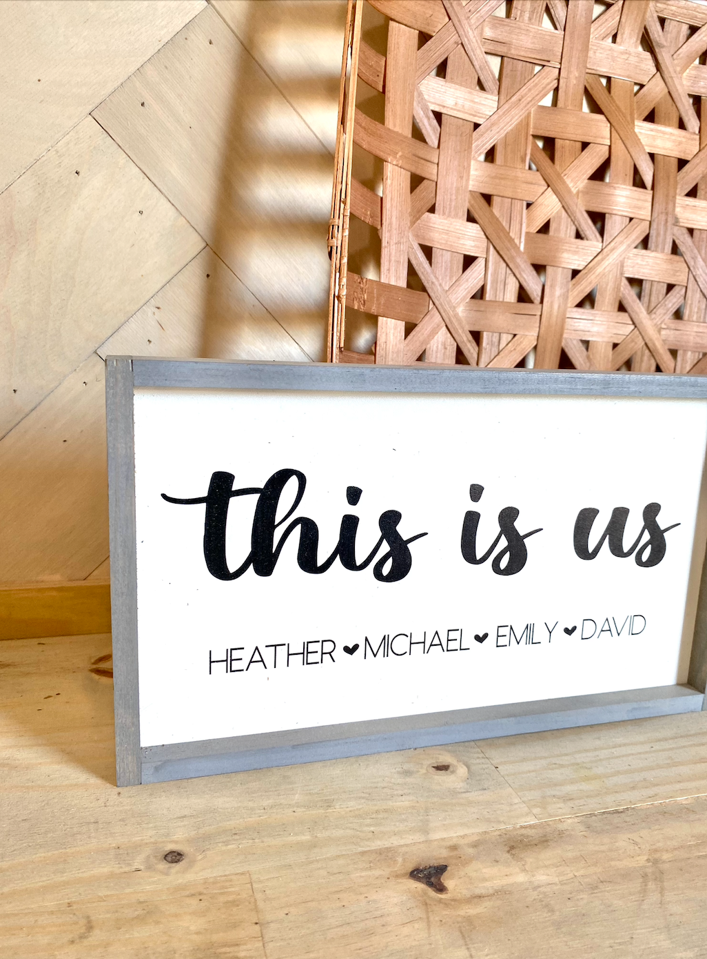 This is us listed family names with heart wood family sign